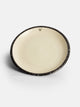 Flat ceramic plate with two-tone enamel