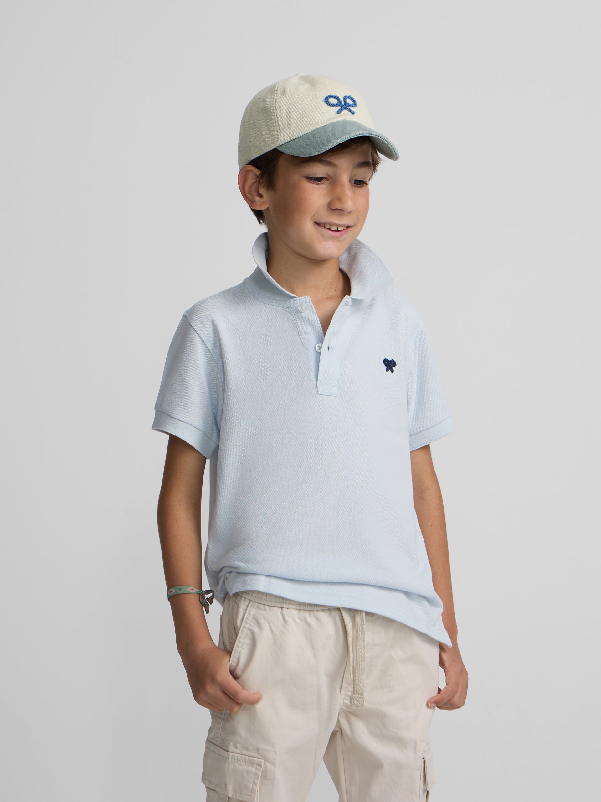 Polo kids liso logo rizo azul claro