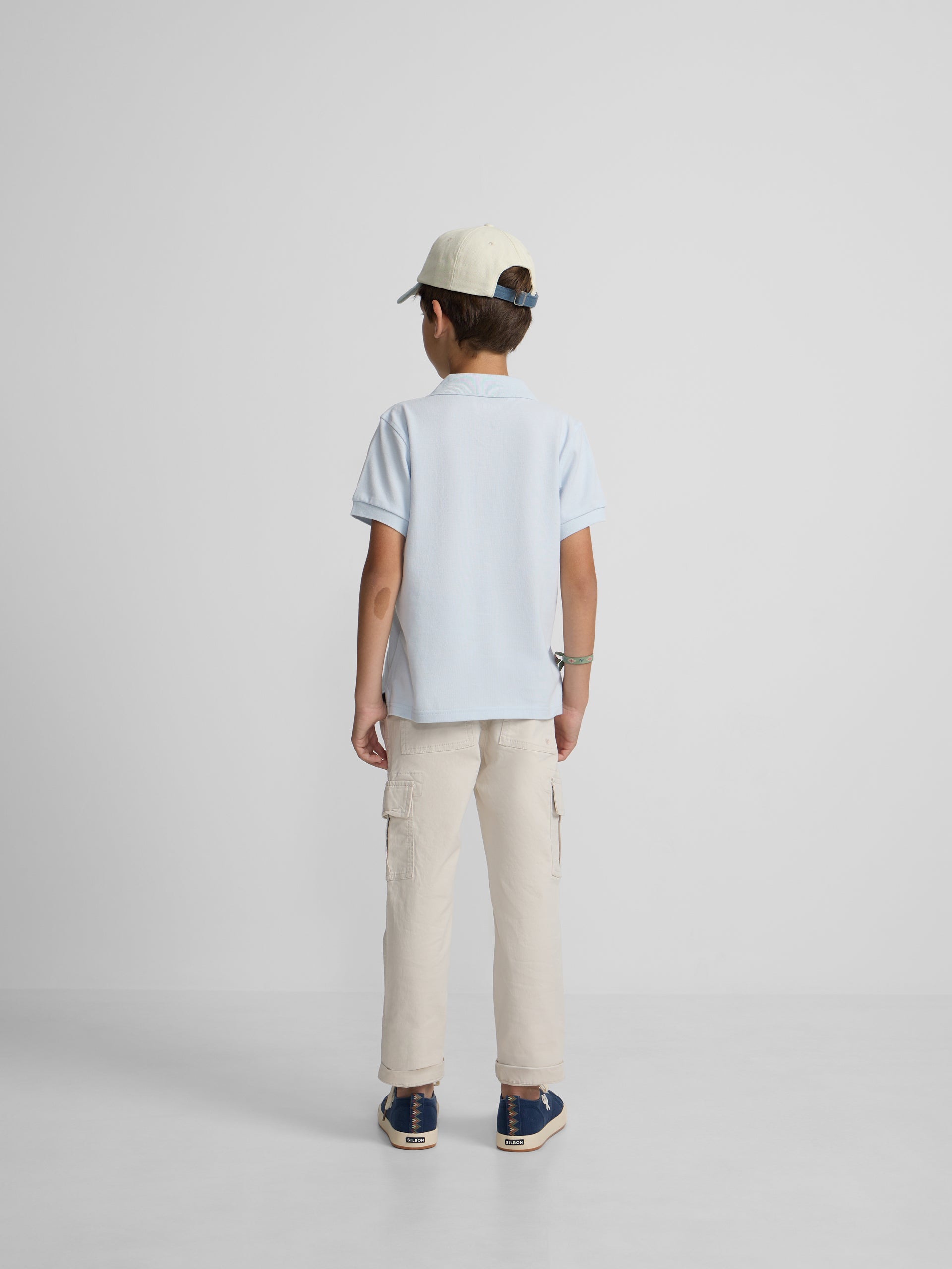 Polo kids liso logo rizo azul claro
