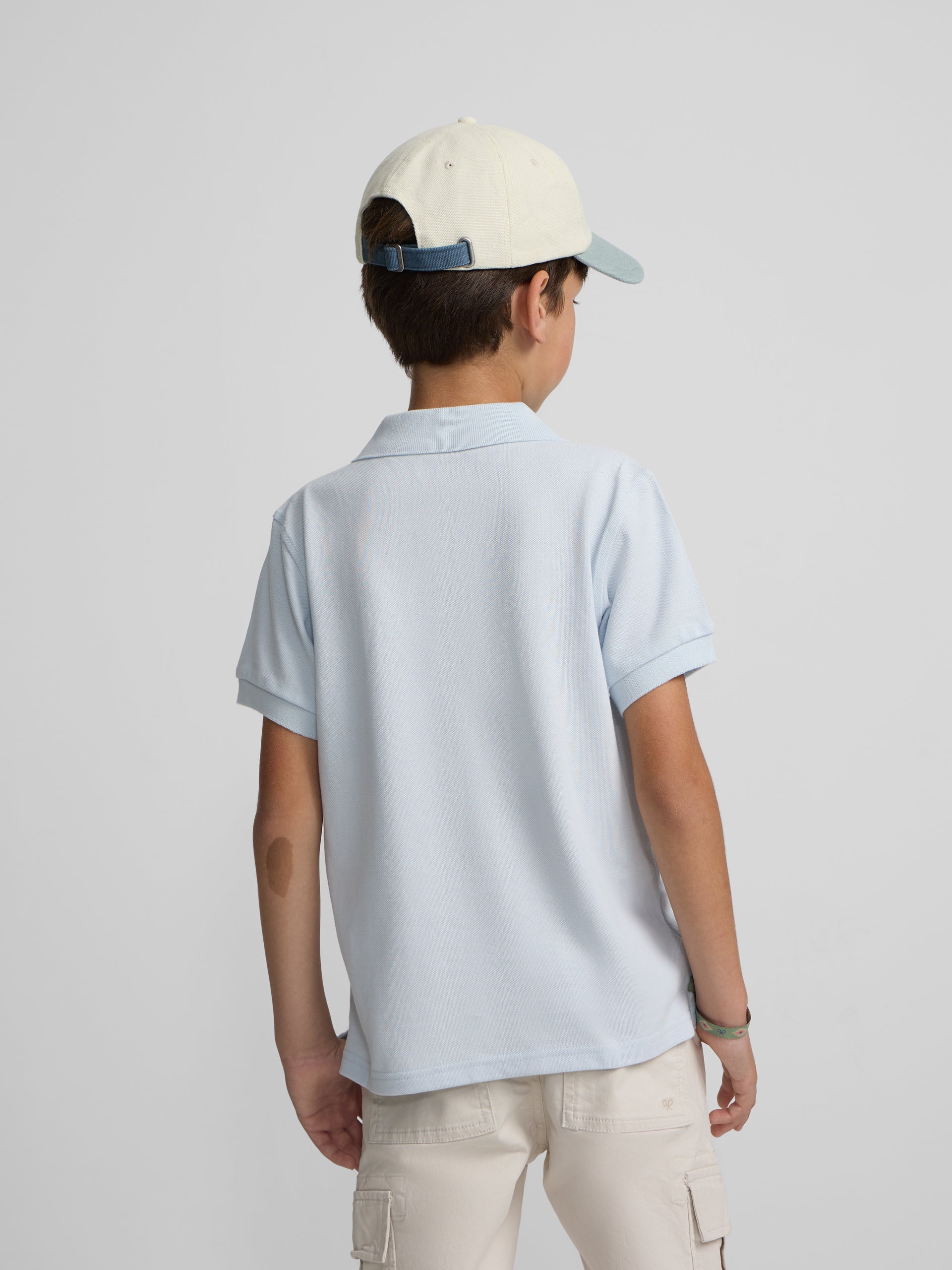 Polo kids liso logo rizo azul claro