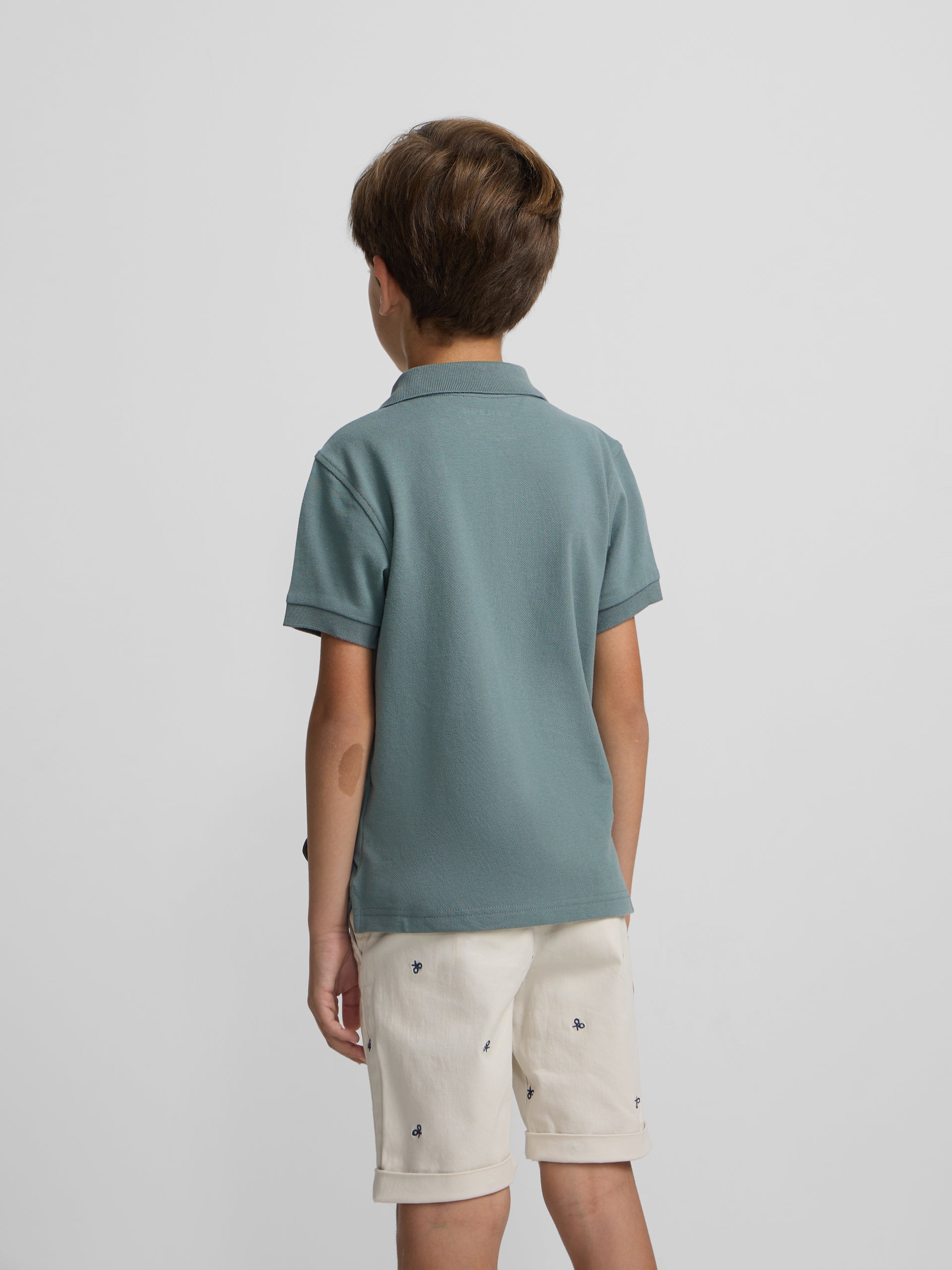 Polo kids liso logo rizo verde oscuro