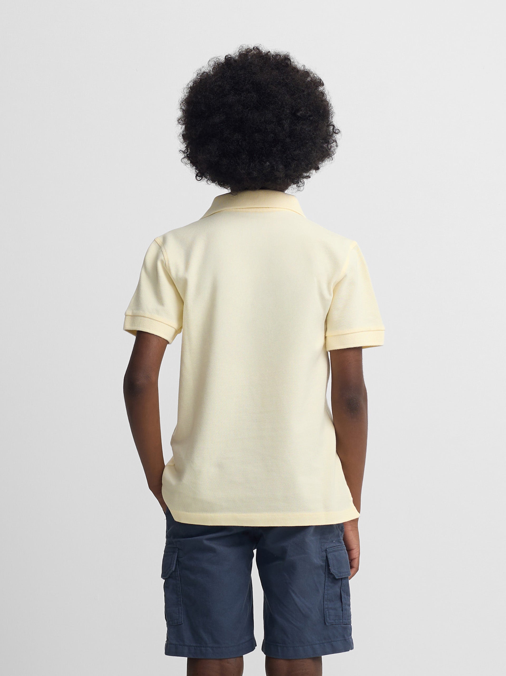Polo kids liso logo rizo amarillo