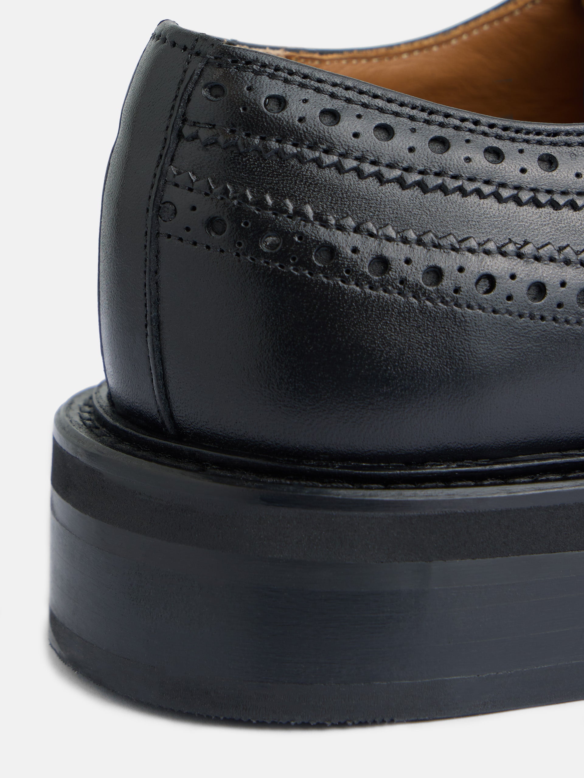 Classic perforated black leather shoe