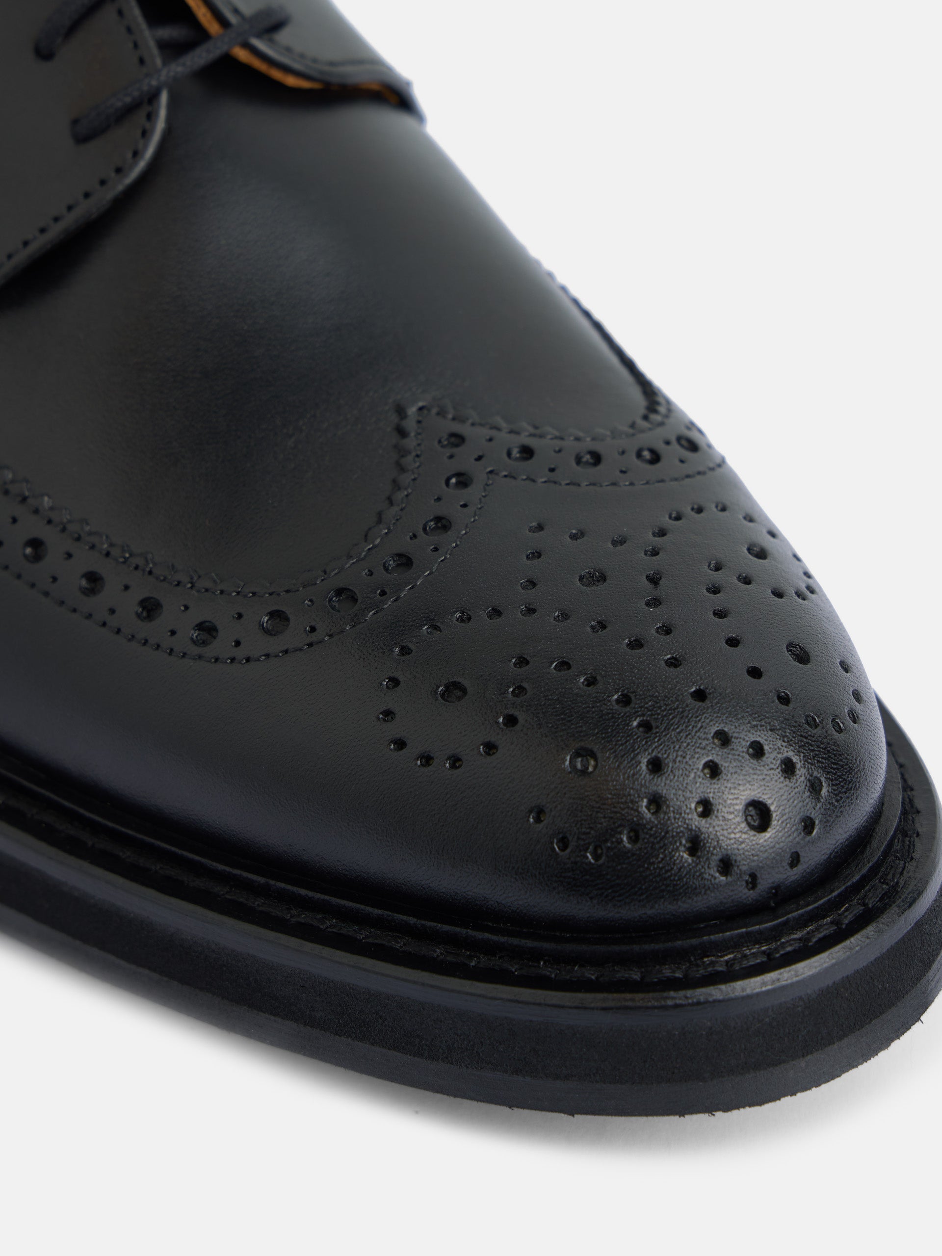 Classic perforated black leather shoe