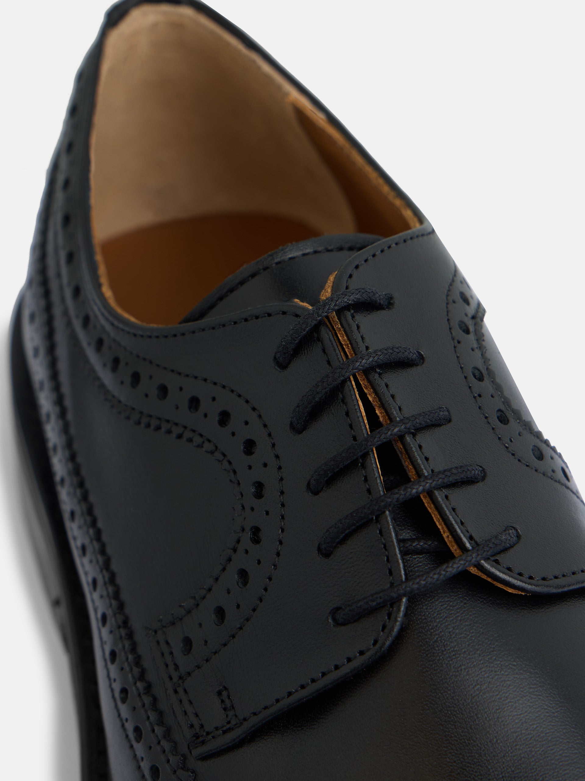 Classic perforated black leather shoe