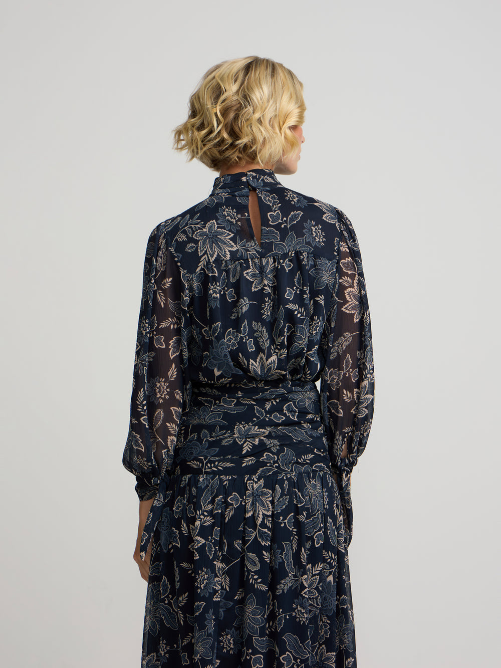 Blue floral print blouse with tied sleeves