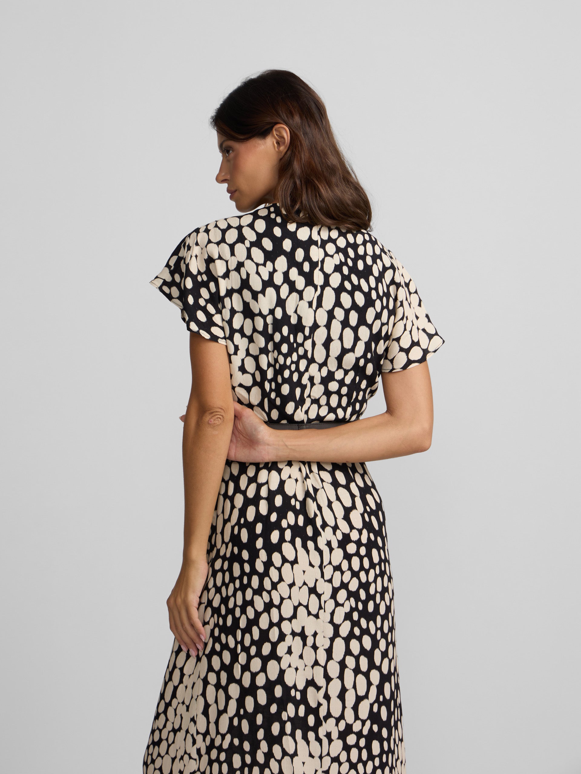 White and black polka dot draped midi dress