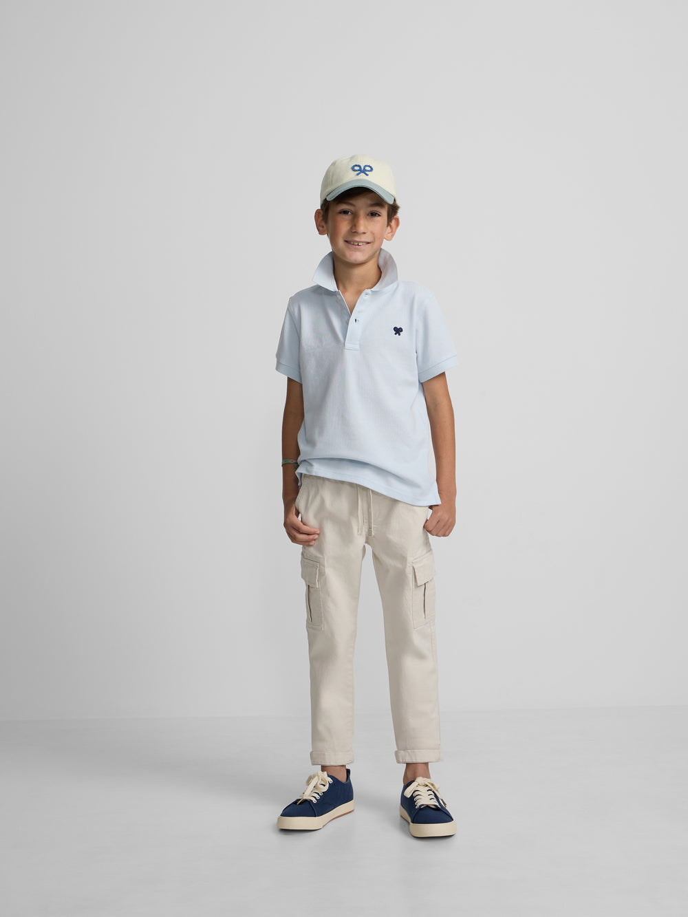 Polo kids liso logo rizo azul claro